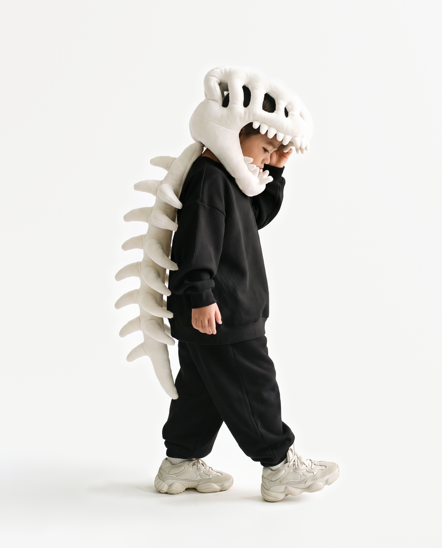 The Dinosaur Skeleton in Bone — plush dinosaur skeleton costume with skull hood and spine, side view