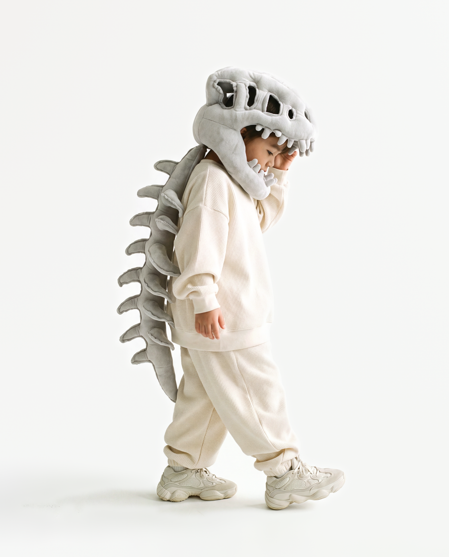 The Dinosaur Skeleton in Grey — plush dinosaur skeleton costume with skull hood and spine, side view