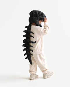The Dinosaur Skeleton in Black — plush dinosaur skeleton costume with skull hood and spine, side view