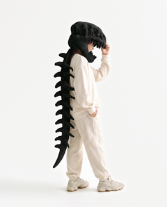 The Dinosaur Skeleton in Black — plush dinosaur skeleton costume with skull hood and spine, side view