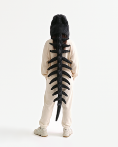 The Dinosaur Skeleton in Black — plush dinosaur skeleton costume seen from behind, spine down the back