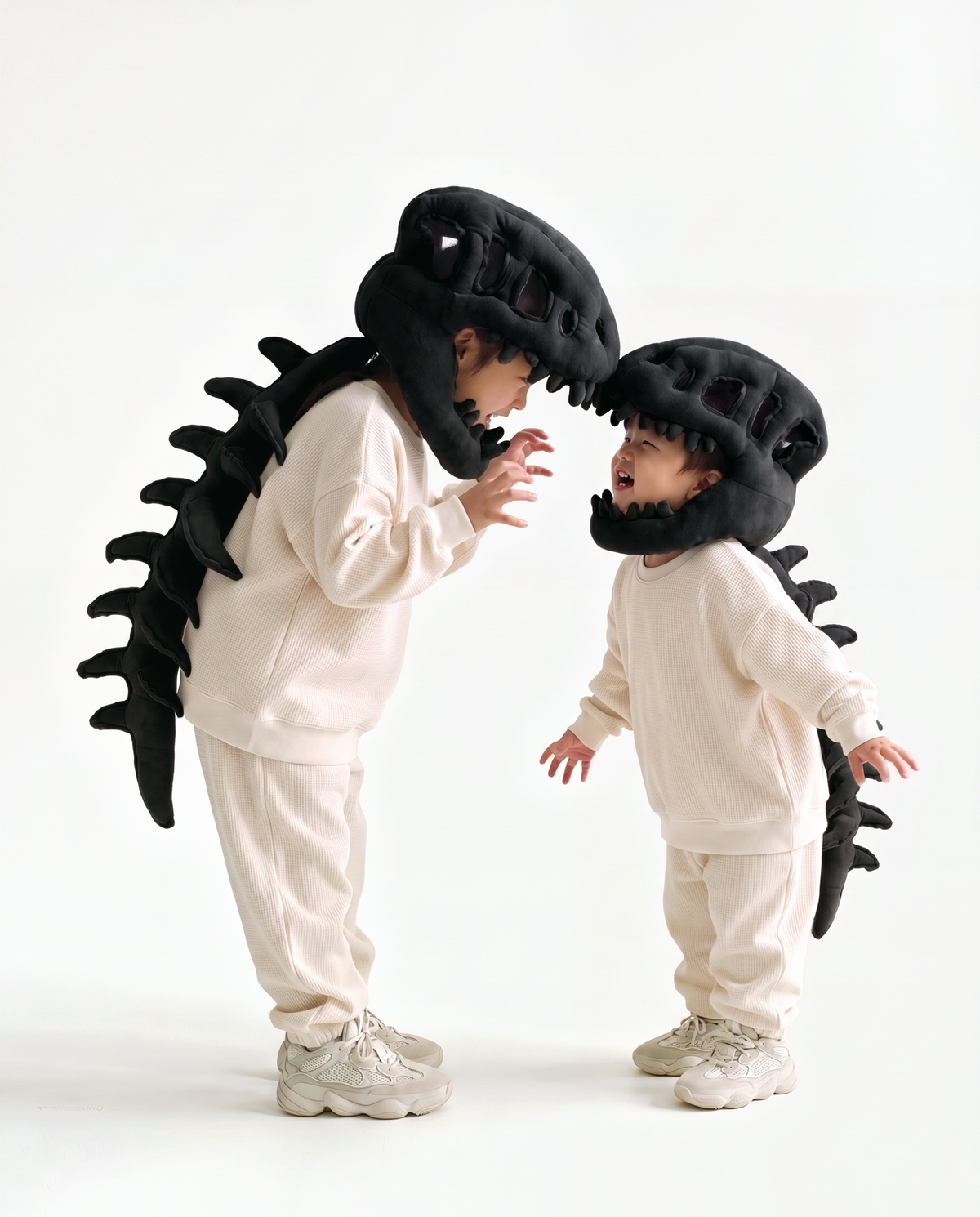 The Dinosaur Skeleton in Black worn with a friend — plush dinosaur skeleton costumes for pairs