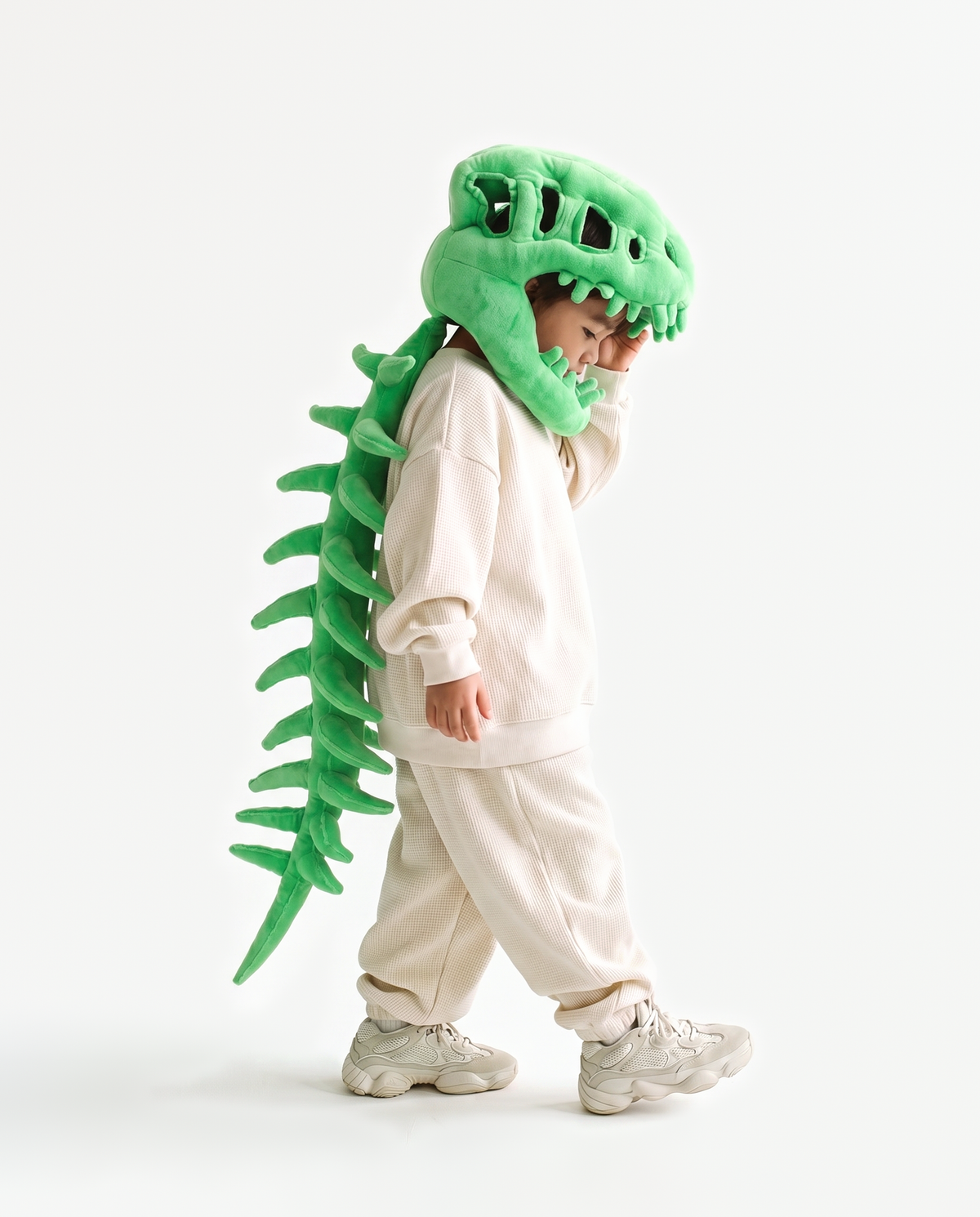 The Dinosaur Skeleton in Green — plush dinosaur skeleton costume seen from behind, spine down the back