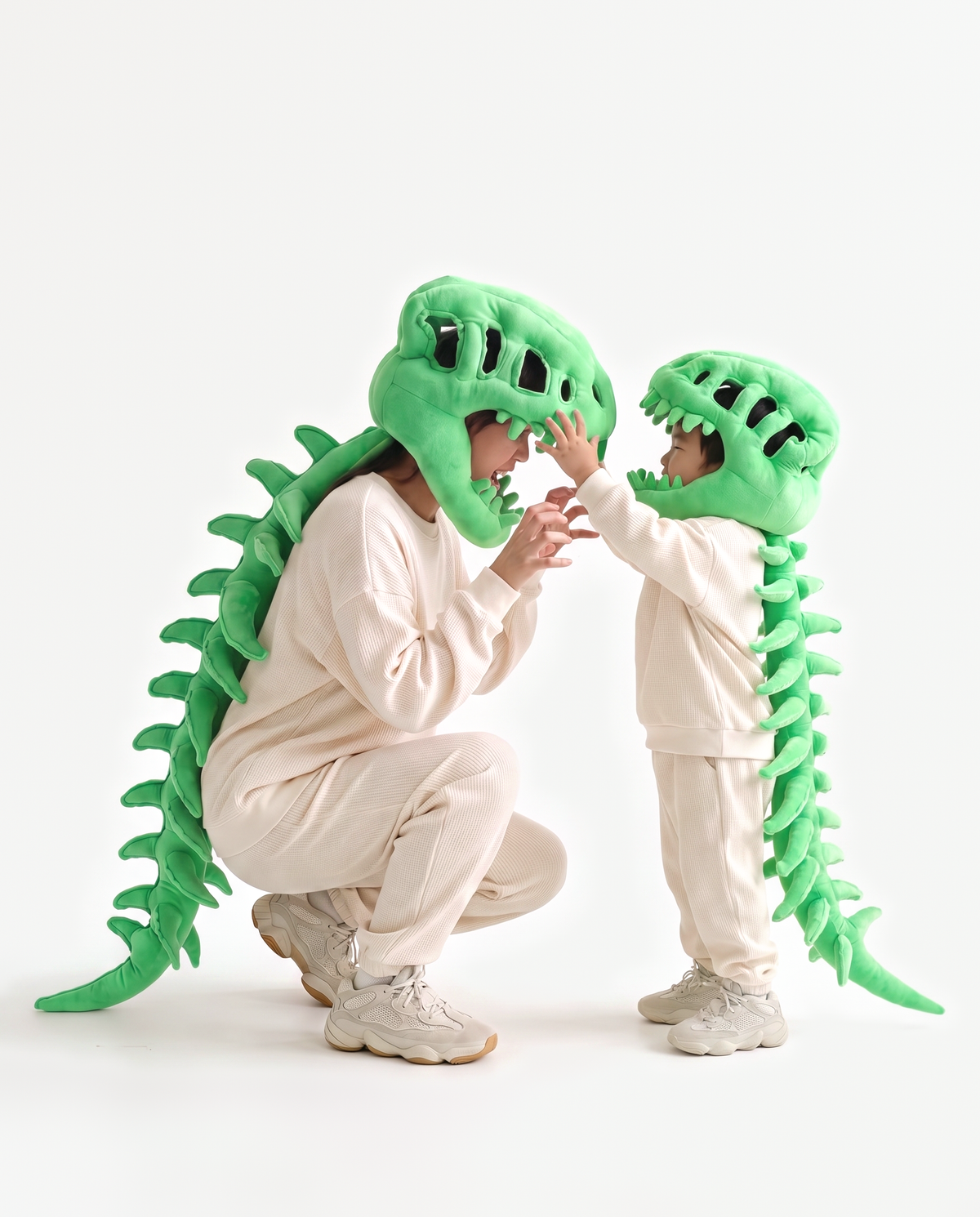 Adult and kids plush Dinosaur Skeleton costumes in Green, crouching together