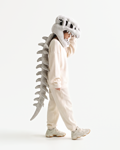 The Dinosaur Skeleton in Grey — plush dinosaur skeleton costume with skull hood and spine, side view