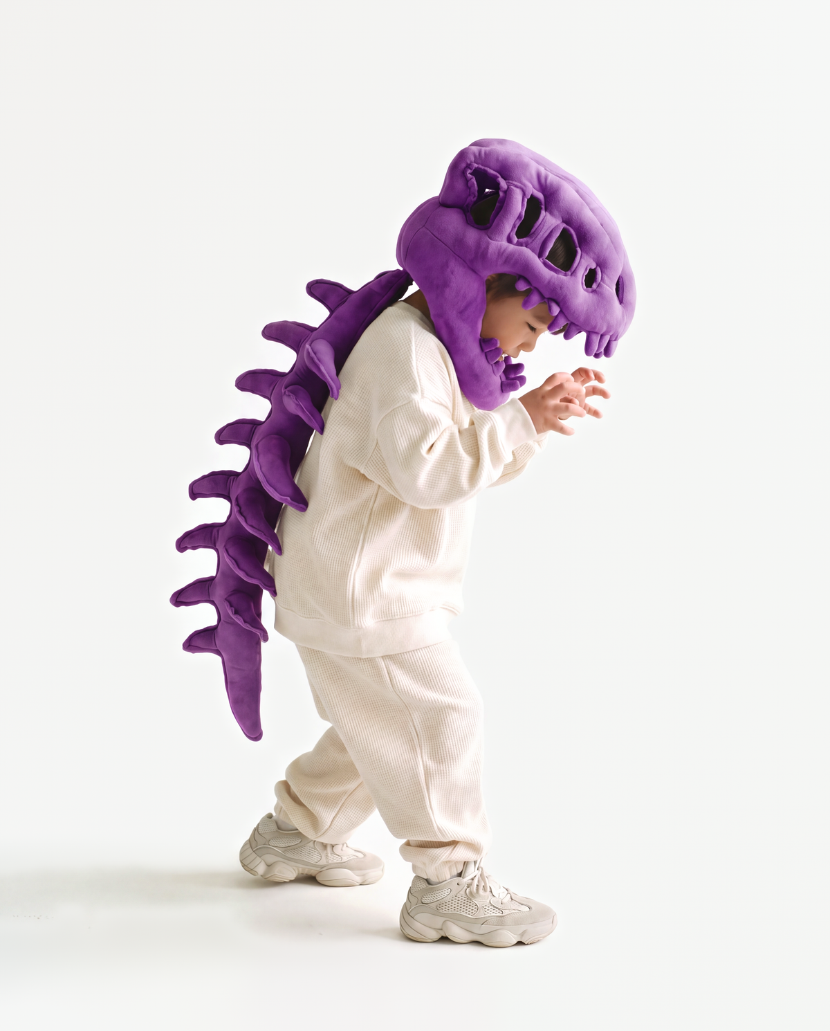 The Dinosaur Skeleton in Purple — plush dinosaur skeleton costume with skull hood and spine, side view