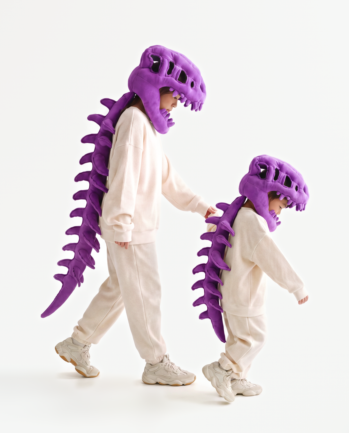 The Dinosaur Skeleton in Purple worn with a friend — plush dinosaur skeleton costumes for pairs