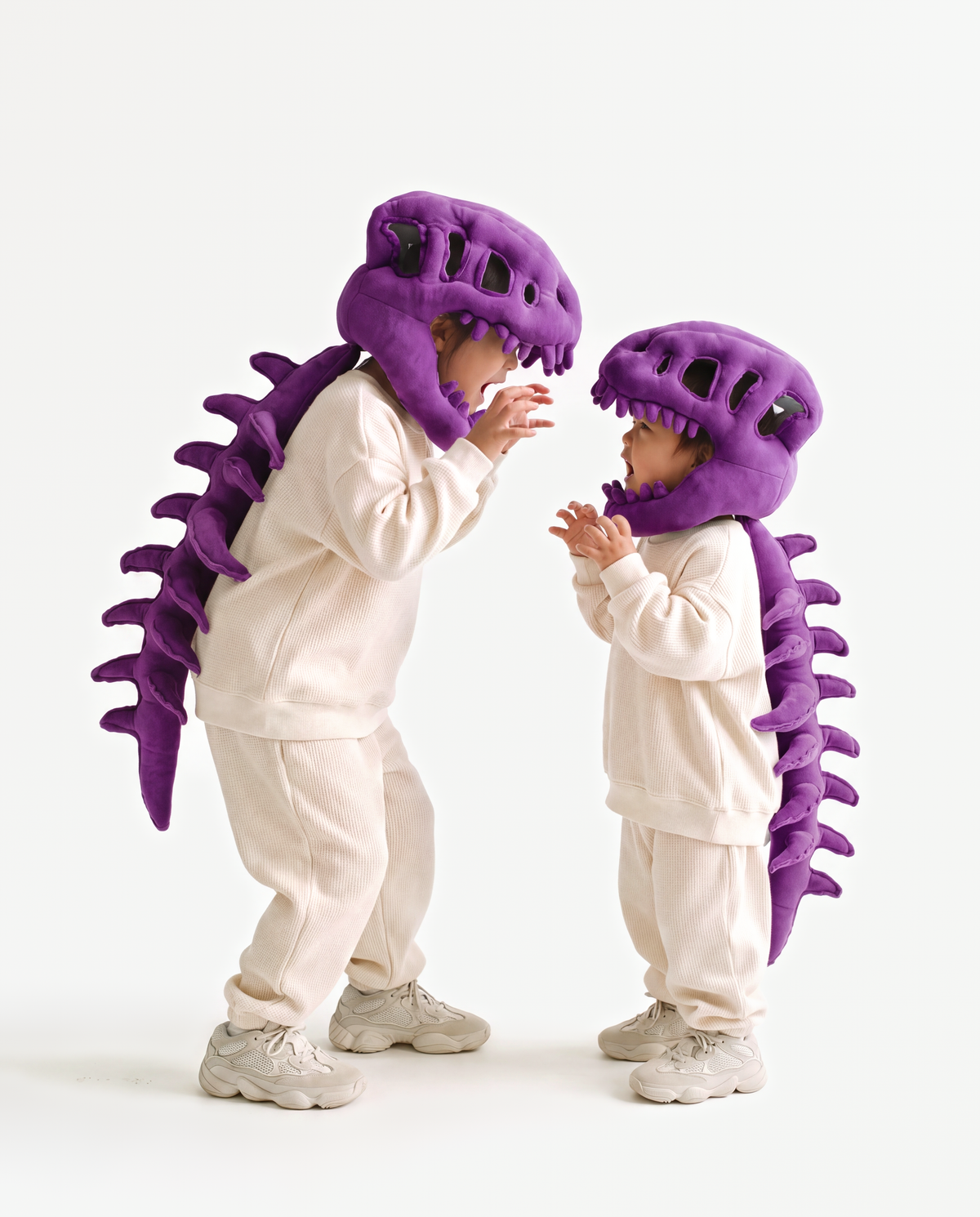 The Dinosaur Skeleton in Purple worn with a friend — plush dinosaur skeleton costumes for pairs