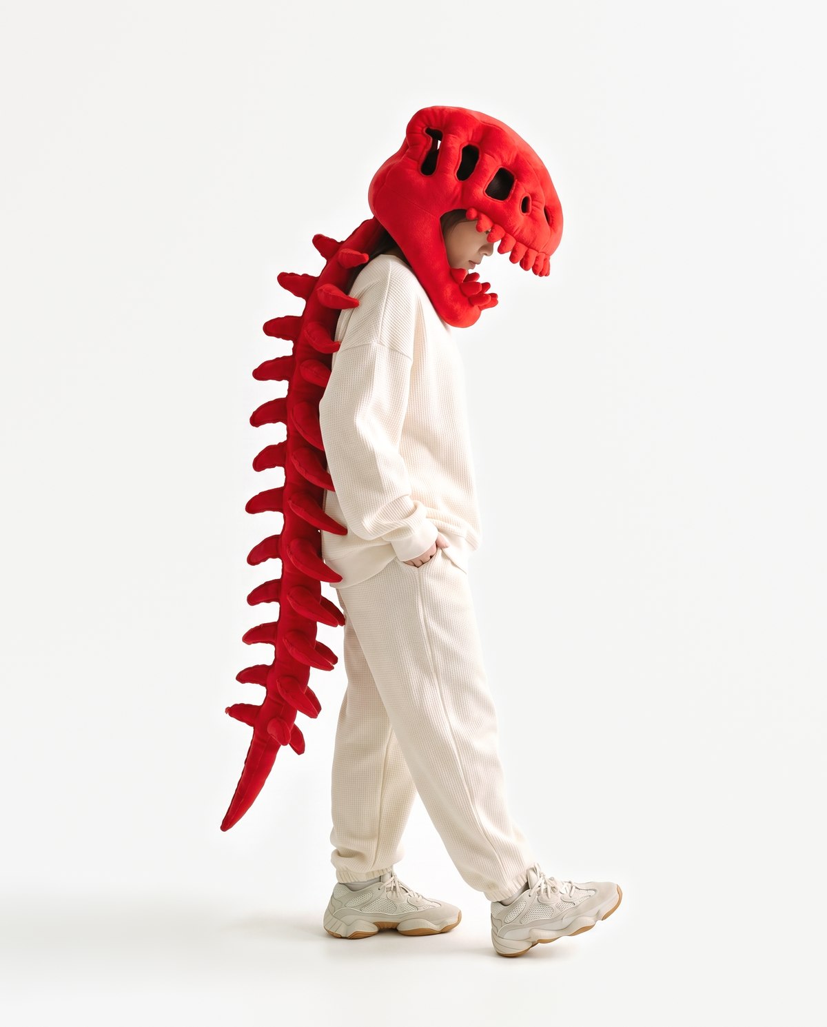 The Dinosaur Skeleton in Red — plush dinosaur skeleton costume with skull hood and spine, side view