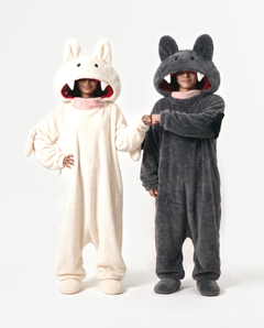 Cream and Charcoal Fang Onesies together — matching monster onesies with fangs for couples