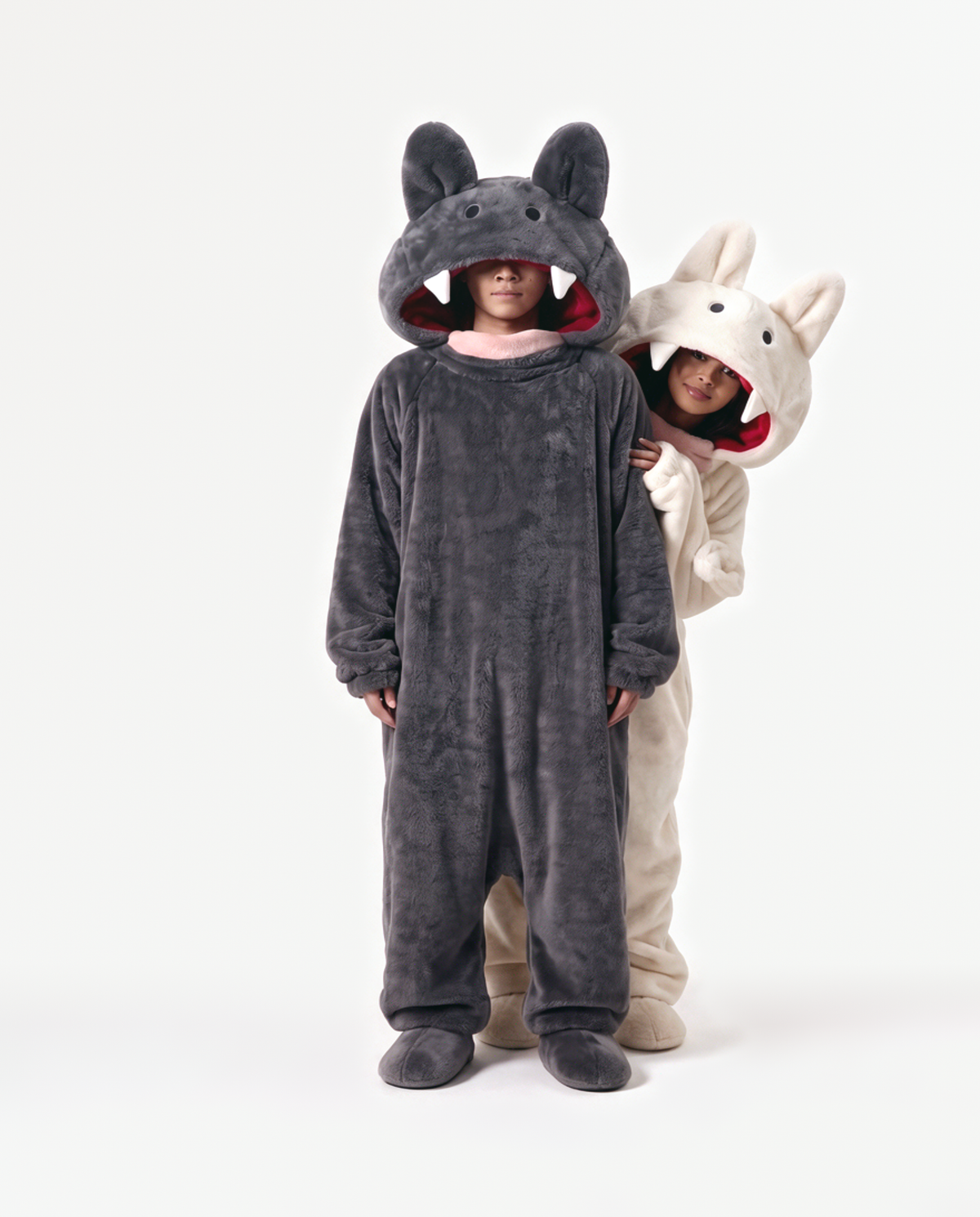 Cream and Charcoal Fang Onesies together — matching monster onesies with fangs for couples