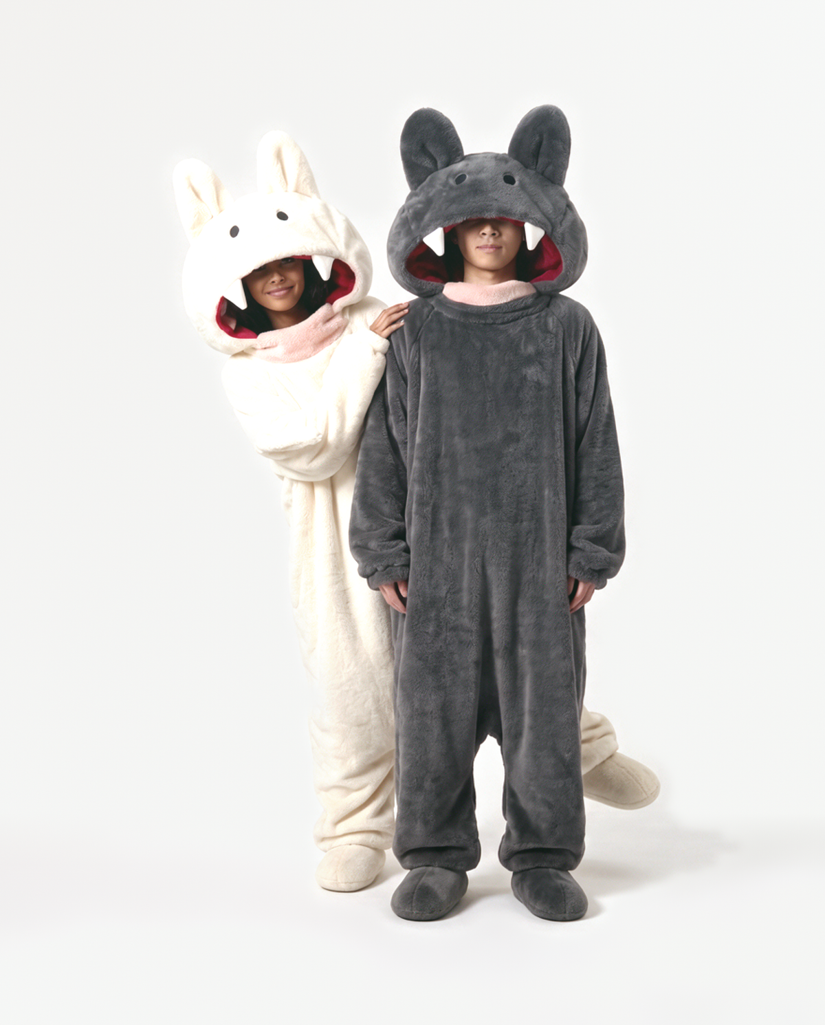 Cream and Charcoal Fang Onesies together — matching monster onesies with fangs for couples